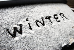 inscription winter on snow on the back window of car
